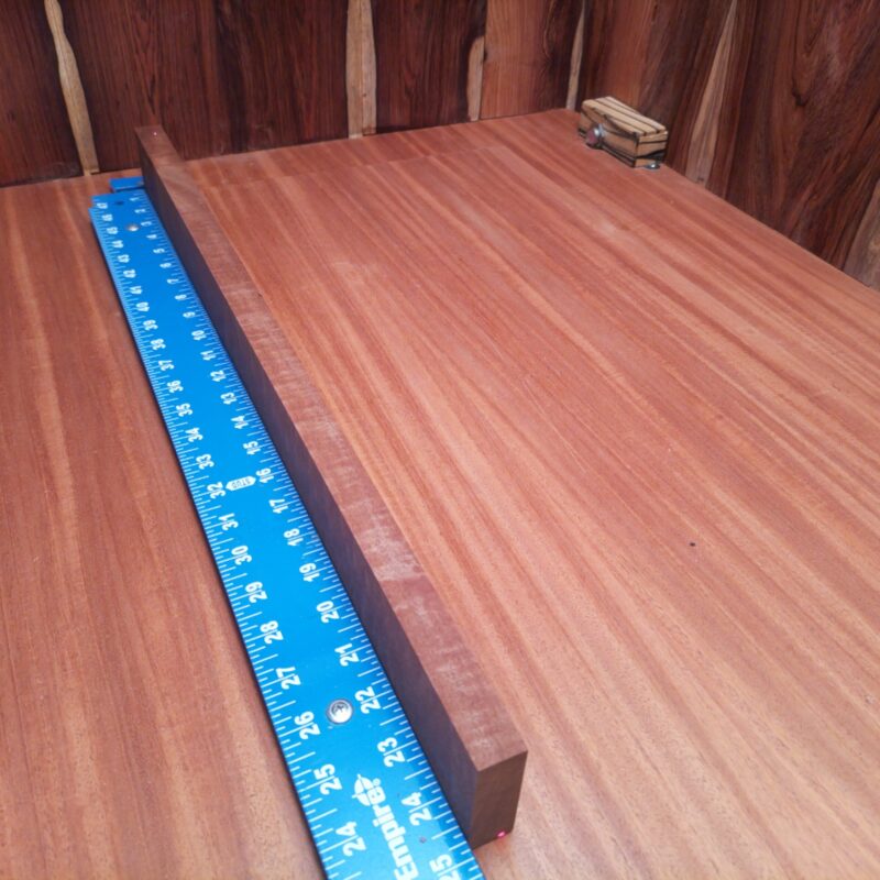 Bubinga 0.8" X 2.2" X 24.7" Wood Blank for Woodworking Projects - ABDL001202 5 Picture this: a luxurious serving tray and wooden coasters from this amazing Bubinga wood, making your dinner parties a hit! Or how about some unique candle holders to brighten up those cozy evenings? Don't forget those high-end drawer pulls—they scream sophistication! With soft, smooth wood, this beauty can jazz up your guitar neck, too. In short, whether it's decor or utility, this wood is pure class! This piece of Bubinga measures 0.8 inches by 2.2 inches by 24.7 inches, offering a high-quality option for a variety of woodworking projects.