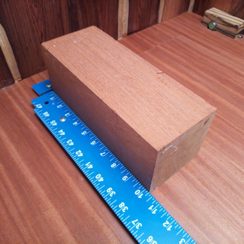 Transform your piece of Honduran Mahogany G1 into a multitude of wonders! With this premium wood, you can create essential coasters, high-end candle holders, and a unique rustic signpost that will surely spark conversations. Or how about conjuring up a wood-turned bowl and delightful picture frame? This wood is your blank canvas, ready for creativity, fun, and a pinch of elegance! This piece of Honduran Mahogany measures 3.8 inches by 3.8 inches by 10.2 inches, offering a high-quality option for a variety of woodworking projects.