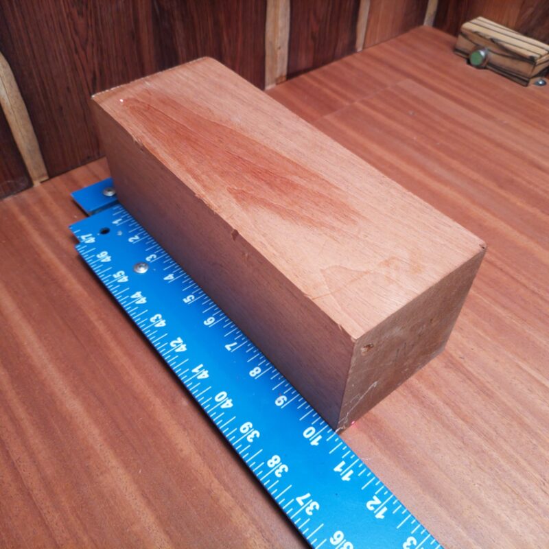 Transform your piece of Honduran Mahogany G1 into a multitude of wonders! With this premium wood, you can create essential coasters, high-end candle holders, and a unique rustic signpost that will surely spark conversations. Or how about conjuring up a wood-turned bowl and delightful picture frame? This wood is your blank canvas, ready for creativity, fun, and a pinch of elegance! This piece of Honduran Mahogany measures 3.8 inches by 3.8 inches by 10.2 inches, offering a high-quality option for a variety of woodworking projects.