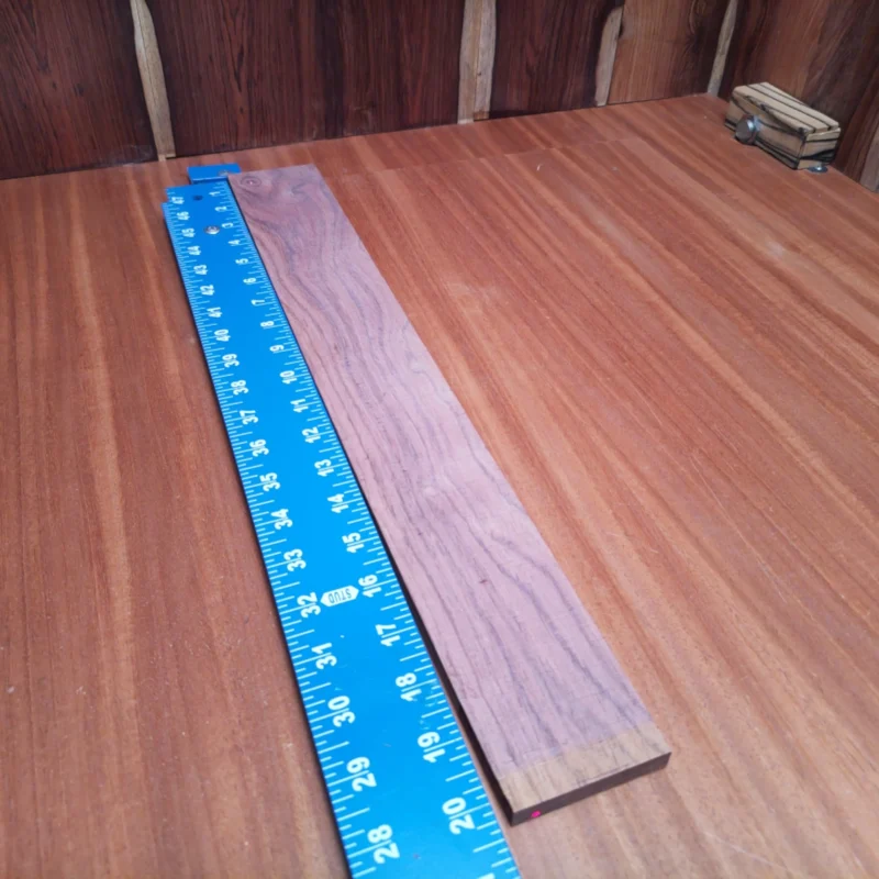Honduran Rosewood Acoustic Flat Sawn Fingerboard Blank 0.4" X 2.7" X 20.2" - HRAFBF000660 3 Crafted from premium Honduran rosewood, this fingerboard blank is perfect for luthiers seeking quality. Its flat-sawn design enhances tonal warmth and projection, ideal for acoustic instruments. With a beautiful surface and easy workability, this fingerboard blank will elevate your craft to new heights. Say goodbye to mediocre materials and hello to the richness of Honduran rosewood, perfect for your next guitar, ukulele, or other stringed creations. It is a Honduran Rosewood Acoustic Flat Sawn fingerboard blank with dimensions of 20.2 x 2.7 x 0.4 inches.