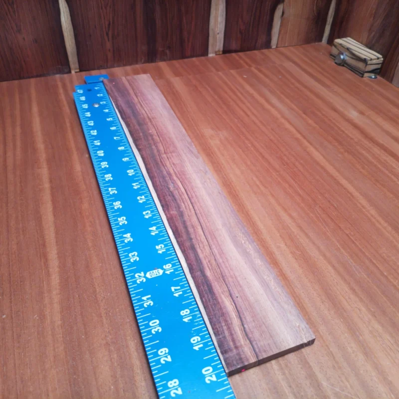 Fingerboard Blanks 27 Unlock your creativity with this premium quarter-sawn Honduran rosewood fingerboard blank. With its striking grain pattern and rich tonal qualities, this wood is perfect for luthiers looking to craft a top-notch acoustic. Experience the blend of durability and beauty that ensures every note rings true. Get ready to elevate your builds with a touch of elegance that only genuine rosewood can provide! It is a Honduran Rosewood Acoustic Quarter Sawn fingerboard blank with dimensions of 20.1 x 3.1 x 0.4 inches.