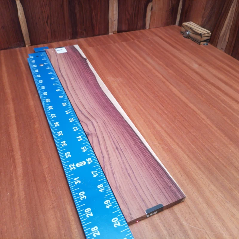 Unlock the potential of your next project with this high-quality Honduran Rosewood blank. Perfect for luthiers seeking rich tones and excellent resonance, this rift-sawn piece offers durability and stunning grain patterns. Elevate your craft and create instruments that deliver both beauty and sonic excellence. This blank is ideal for guitar backs and sides, ensuring your creations stand out in tone and aesthetics. It is a Honduran Rosewood Acoustic Rift Sawn fingerboard blank with dimensions of 20.3 x 3.5 x 0.4 inches.
