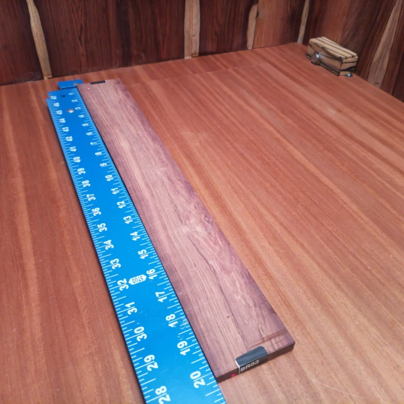 Fingerboard Blanks 115 Unleash your creativity with this rift sawn Honduran Rosewood blank, perfect for luthiers. Enhance your projects with its rich tonal qualities and stunning grain patterns. Designed to impress, this blank is ideal for crafting acoustic guitars that resonate beautifully. Let your imagination run wild as you shape this premium wood into your next masterpiece for exceptional sound and style. It is a Honduran Rosewood Acoustic Rift Sawn fingerboard blank with dimensions of 20.2 x 2.7 x 0.4 inches.