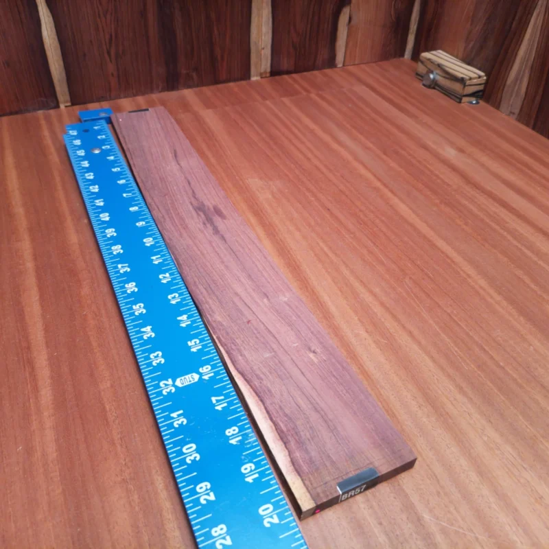 Honduran Rosewood Acoustic Rift Sawn Fingerboard Blank 0.4" X 2.6" X 20.2" - HRAFBR000057 3 Craft your masterpiece with this Honduran Rosewood blank, perfect for luthiers seeking rich tonal quality. Its refined rift-sawn grain enhances both aesthetics and sound, resulting in a premium build for your acoustic instrument. Ideal for creating resonant back and sides or luxurious fingerboards, this wood strikes the perfect balance between structure and beauty. Elevate your craftsmanship and inspire your next project with this stunning rosewood! It is a Honduran Rosewood Acoustic Rift Sawn fingerboard blank with dimensions of 20.2 x 2.6 x 0.4 inches.