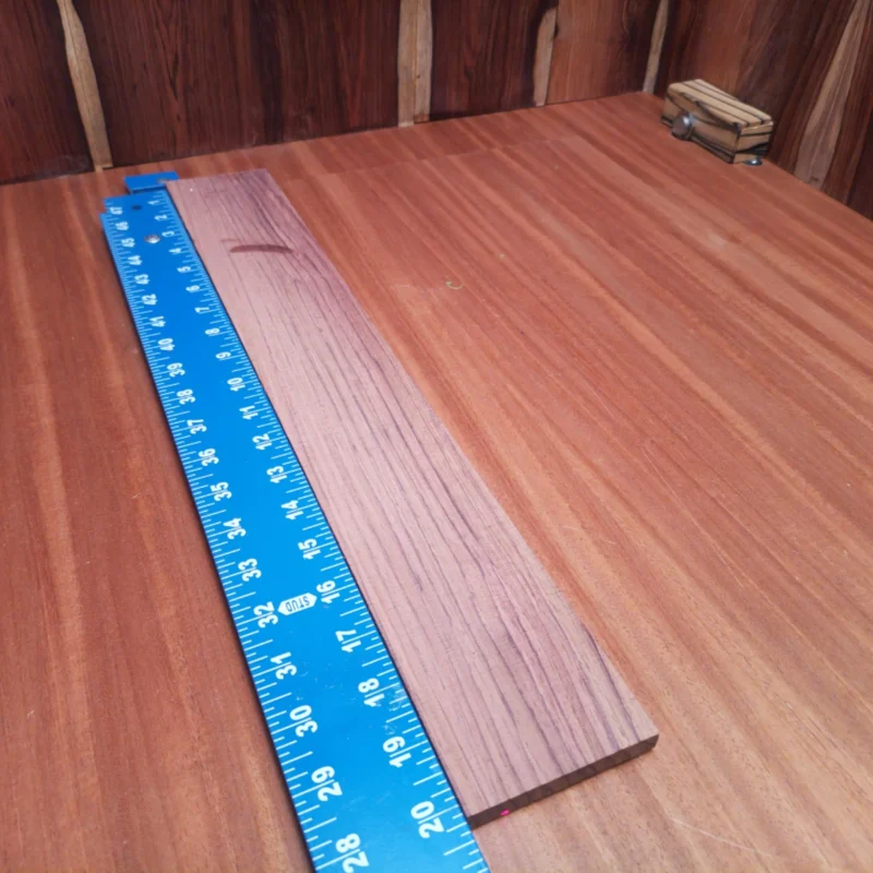 Unlock the potential of your next acoustic masterpiece with this Honduran Rosewood blank. Designed for luthiers who appreciate quality, its rift sawn cut showcases a stunning grain pattern ideal for vibrant sound projection and resonance. Whether you're crafting a new guitar or refining an old one, this fingerboard will elevate your instrument's aesthetic and acoustic performance to professional levels. Get ready to impress your audience! It is a Honduran Rosewood Acoustic Rift Sawn fingerboard blank with dimensions of 20.2 x 3.0 x 0.4 inches.