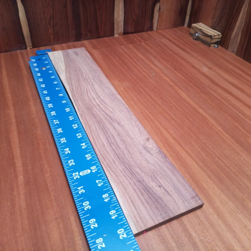 Elevate your instrument making with this Honduran Rosewood acoustic blank. Its rift sawn design showcases a beautiful grain, ideal for luthiers seeking quality and aesthetics. This fingerboard blank balances durability and resonance, promising a rich sound. Perfect for guitars, ukuleles, or other string instruments, it's easy to work with and guarantees a sturdy fit. Transform your next project with this stunning wood and let your creativity flow! It is a Honduran Rosewood Acoustic Rift Sawn fingerboard blank with dimensions of 20.3 x 3.9 x 0.4 inches.