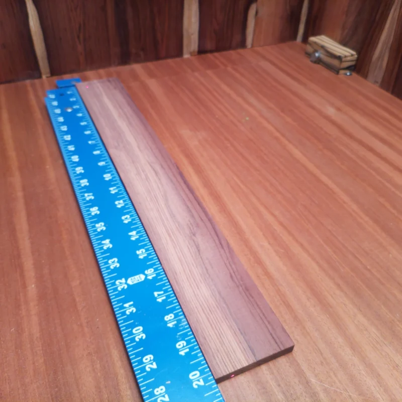 Honduran Rosewood Acoustic Rift Sawn Fingerboard Blank 0.4" X 2.7" X 20.2" - HRAFBR000091 3 Upgrade your crafting with this stunning Honduran Rosewood blank. Perfect for luthiers, its rift-sawn dimensions ensure a reliable, consistent tone while delivering a rich aesthetic that's recognizable and sought-after by professionals. This wood is not just beautiful; it’s acoustically talented, making it the go-to choice for your next project. Elevate your instrument's sound and style today! It is a Honduran Rosewood Acoustic Rift Sawn fingerboard blank with dimensions of 20.2 x 2.7 x 0.4 inches.