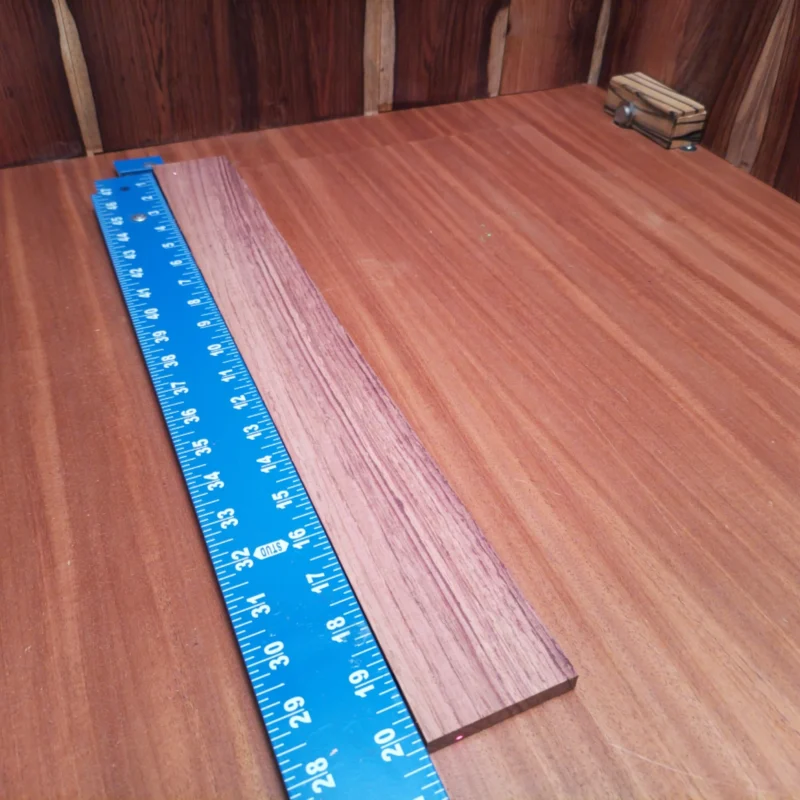 Fingerboard Blanks 82 Crafted from beautiful Honduran Rosewood, this acoustic fingerboard blank delivers outstanding tonal richness and durability. Perfect for luthiers, it's ideal for custom guitars seeking that remarkable warmth and resonance. Its rift sawn design ensures consistent grain patterns, making this blank not only functional but visually appealing as well. Elevate your instrument-building projects with this premium quality wood, guaranteed to impress players of all levels. It is a Honduran Rosewood Acoustic Rift Sawn fingerboard blank with dimensions of 20.3 x 2.5 x 0.4 inches.