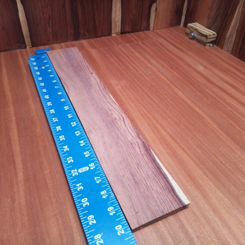 Craft your next acoustic masterpiece with this Honduran Rosewood Blank. Boasting a beautifully rift-sawn surface, it delivers superior tonal qualities and aesthetic appeal. Ideal for luthiers seeking durability and a rich, warm sound. With easy workability and striking grain patterns, this fingerboard blank is your ticket to making instruments that resonate with character and quality at every note. It is a Honduran Rosewood Acoustic Rift Sawn fingerboard blank with dimensions of 20.2 x 3.2 x 0.4 inches.