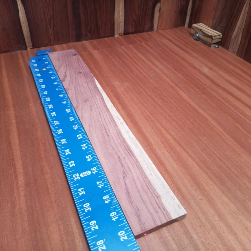 Honduran Rosewood Acoustic Rift Sawn Fingerboard Blank 0.4" X 2.8" X 20.2" - HRAFBR000104 3 Elevate your craft with this stunning Honduran Rosewood blank, designed specifically for acoustic instruments. Known for its bright tone and powerful sustain, this rift-sawn wood delivers exceptional resonance and visual appeal. Perfect for luthiers seeking to create high-quality guitars, ukuleles, and more, this blank will add character and depth to your next project. Unleash your creativity and let this beautiful hardwood become the heart of your instrument. It is a Honduran Rosewood Acoustic Rift Sawn fingerboard blank with dimensions of 20.2 x 2.8 x 0.4 inches.
