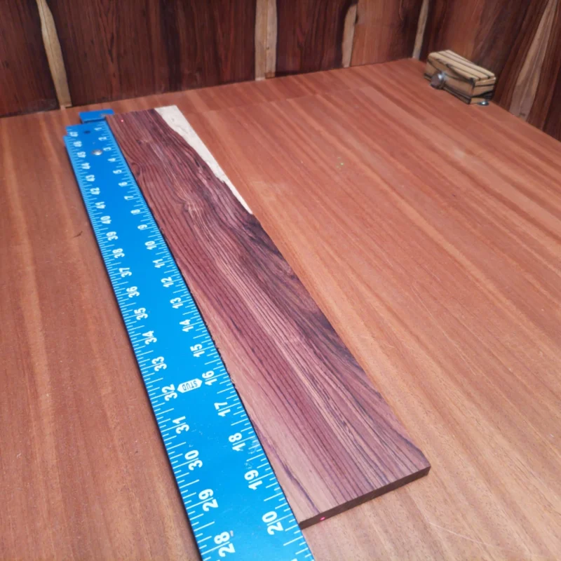 Unleash your creativity with this premium Honduran rosewood blank, perfect for crafting stunning acoustic instruments. Its rich, nuanced tones and striking grain patterns make it an excellent choice for luthiers looking to elevate their projects. Ideal for fingerboard construction, this durable wood promises a blend of beauty and performance that will leave players impressed. Get ready to create masterpieces that resonate with every strum! It is a Honduran Rosewood Acoustic Rift Sawn fingerboard blank with dimensions of 20.3 x 3.2 x 0.4 inches.