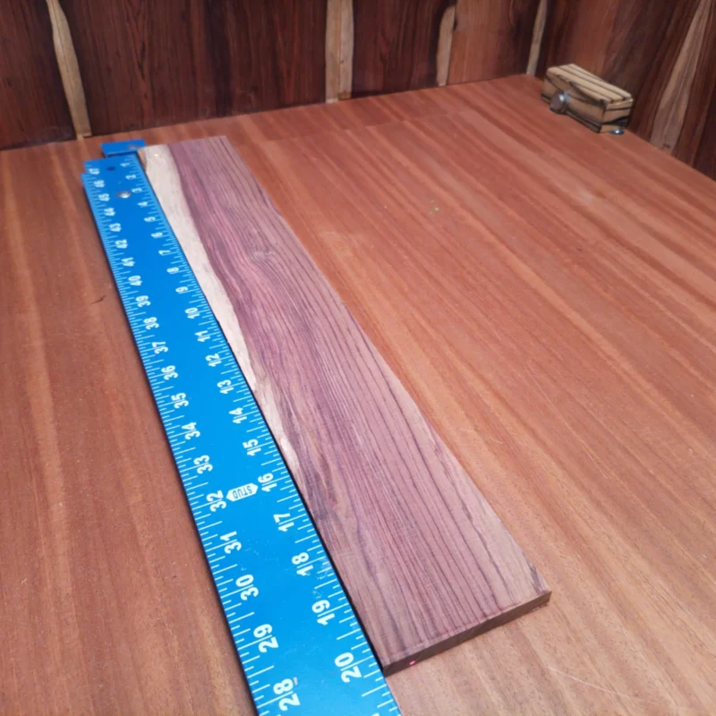 Honduran Rosewood Acoustic Rift Sawn Fingerboard Blank 0.4" X 3.2" X 20.3" - HRAFBR000105 3 Unleash your creativity with this premium Honduran rosewood blank, perfect for crafting stunning acoustic instruments. Its rich, nuanced tones and striking grain patterns make it an excellent choice for luthiers looking to elevate their projects. Ideal for fingerboard construction, this durable wood promises a blend of beauty and performance that will leave players impressed. Get ready to create masterpieces that resonate with every strum! It is a Honduran Rosewood Acoustic Rift Sawn fingerboard blank with dimensions of 20.3 x 3.2 x 0.4 inches.
