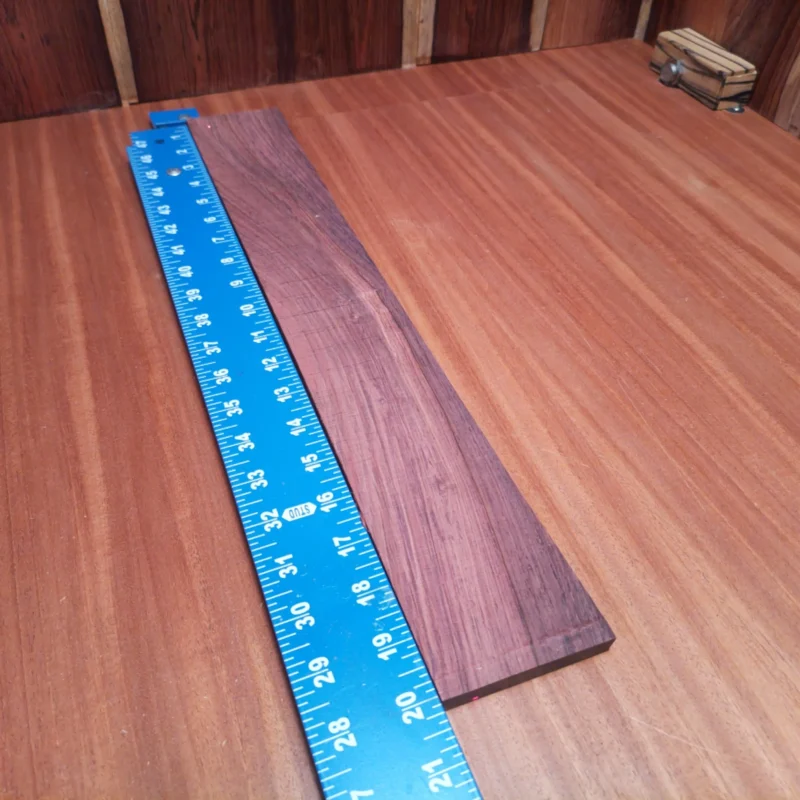 Honduran Rosewood Acoustic Rift Sawn Fingerboard Blank 0.3" X 2.8" X 20.0" - HRAFBR000143 3 Crafted from premium Honduran Rosewood, this fingerboard blank delivers stunning aesthetics and superior playability. Instrument builders will appreciate its rich tonal qualities and the unique character of each piece, ideal for creating exceptional acoustics. With its stable grain pattern and durability, this blank ensures your string instruments will not only sound amazing but look fantastic. Elevate your craft with a quality that makes a lasting impression! It is a Honduran Rosewood Acoustic Rift Sawn fingerboard blank with dimensions of 20.0 x 2.8 x 0.3 inches.