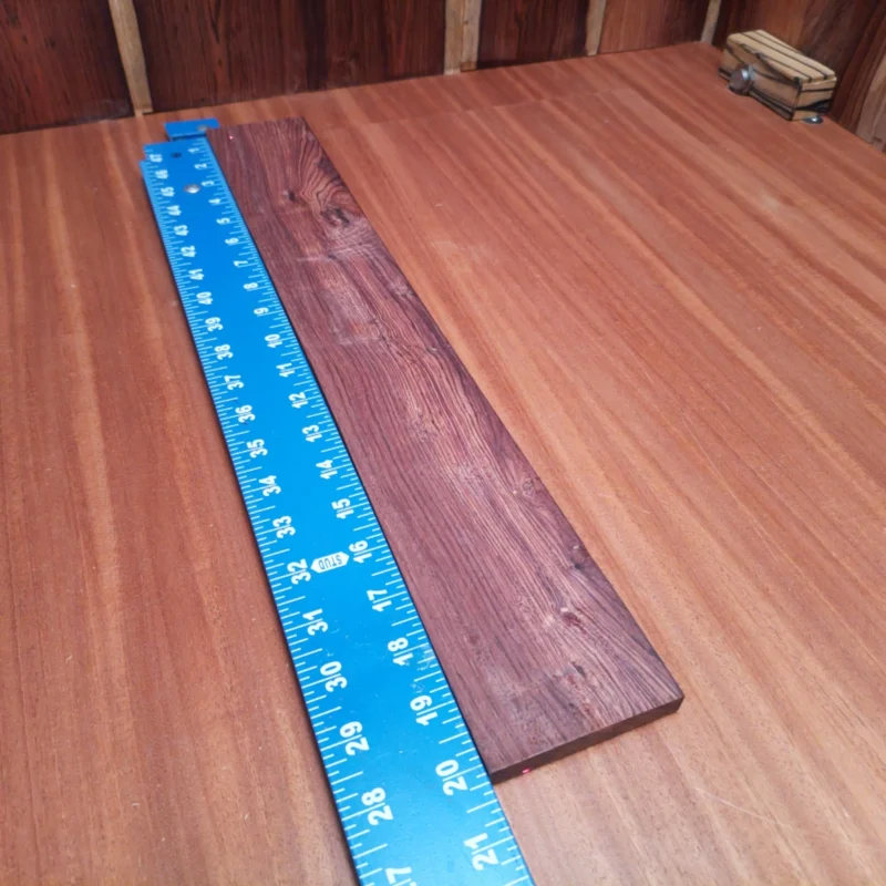 Fingerboard Blanks 34 Transform your builds with this premium Honduran Rosewood blank. Its unique rift sawn cut ensures remarkable tonal qualities, rich character, and stunning aesthetics for your acoustic instruments. Ideal for luthiers seeking the perfect balance of beauty and functionality, this blank promises to elevate your craft. Get ready to impress both the eyes and ears with your next creation! It is a Honduran Rosewood Acoustic Rift Sawn fingerboard blank with dimensions of 20.1 x 2.8 x 0.3 inches.