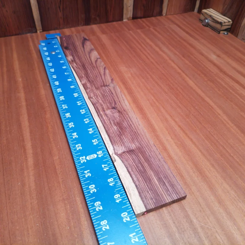 Fingerboard Blanks 141 Unleash your creativity with this premium Honduran Rosewood blank! Perfectly crafted for luthiers, it promises a robust tone and striking aesthetics. This fingerboard blank delivers excellent resonance and playability, ensuring a fantastic playing experience. Whether you’re crafting or customizing, this versatile wood is your perfect partner for stunning instruments that will stand out on any stage. It is a Honduran Rosewood Acoustic Rift Sawn fingerboard blank with dimensions of 20.0 x 2.8 x 0.4 inches.