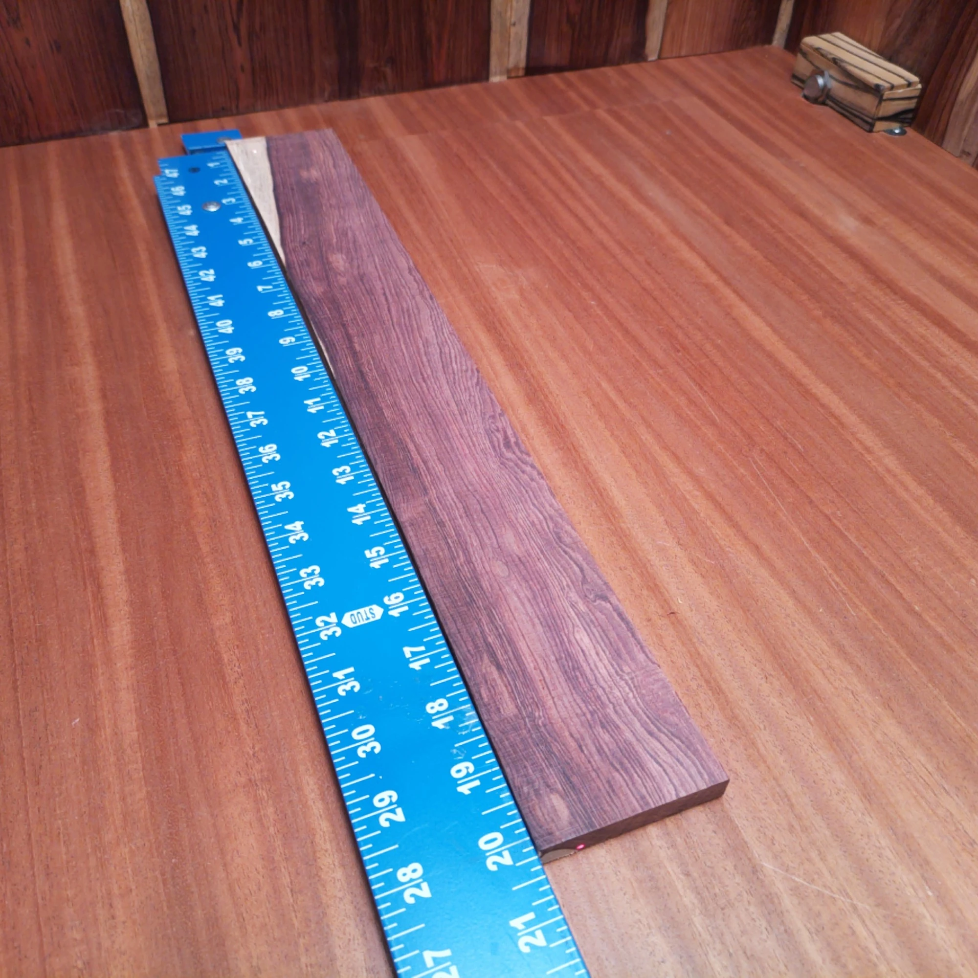 Honduran Rosewood Acoustic Rift Sawn Fingerboard Blank 0.4" X 2.8" X 20.2" - HRAFBR000165 1 Elevate your crafting with this Honduran Rosewood Acoustic blank. With its rift-sawn design, this wood showcases stunning grain patterns and rich tonal character. Perfect for luthiers seeking durability and a warm, resonant sound in their acoustic builds. Get ready to turn heads and ears with your next project using this beautiful, versatile wood. It is a Honduran Rosewood Acoustic Rift Sawn fingerboard blank with dimensions of 20.2 x 2.8 x 0.4 inches.