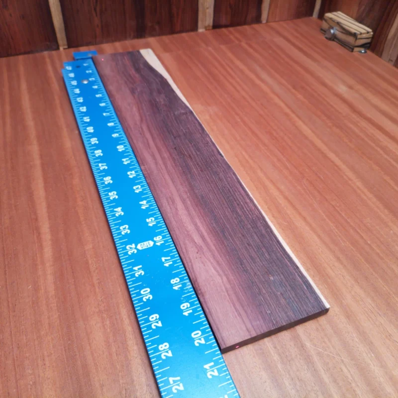 Fingerboard Blanks 68 Elevate your instrument-making game with this Honduran Rosewood blank. Featuring rich, warm tones, it’s perfect for crafting premium acoustic guitars. Its rift sawn grain provides stability and aesthetic appeal, ensuring a striking finish while maximizing resonance. Ideal for luthiers seeking quality and reliability in their projects. Get ready to produce beautiful soundscapes with this versatile wood! It is a Honduran Rosewood Acoustic Rift Sawn fingerboard blank with dimensions of 20.5 x 3.8 x 0.3 inches.