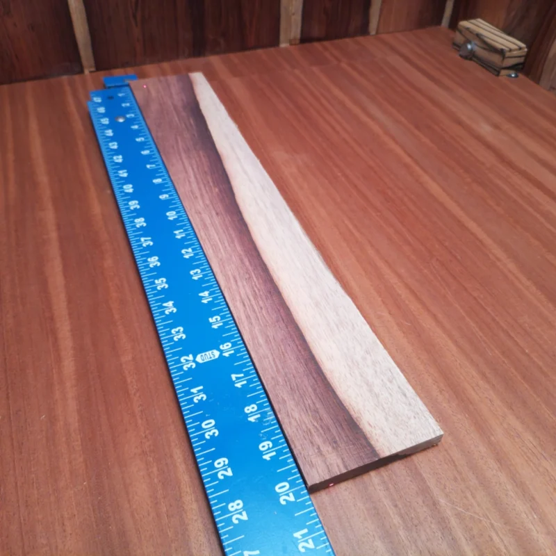 Honduran Rosewood Acoustic Rift Sawn Fingerboard Blank 0.4" X 3.3" X 20.0" - HRAFBR000202 3 Unlock your creative potential with this premium Honduran Rosewood blank, perfect for luthiers. Its rich tonal qualities offer a warm, resonant sound that will elevate any acoustic instrument. With striking grain patterns, this wood not only performs beautifully but also looks stunning in all your creations. Get ready to craft a masterpiece that sounds as great as it looks! It is a Honduran Rosewood Acoustic Rift Sawn fingerboard blank with dimensions of 20.0 x 3.3 x 0.4 inches.