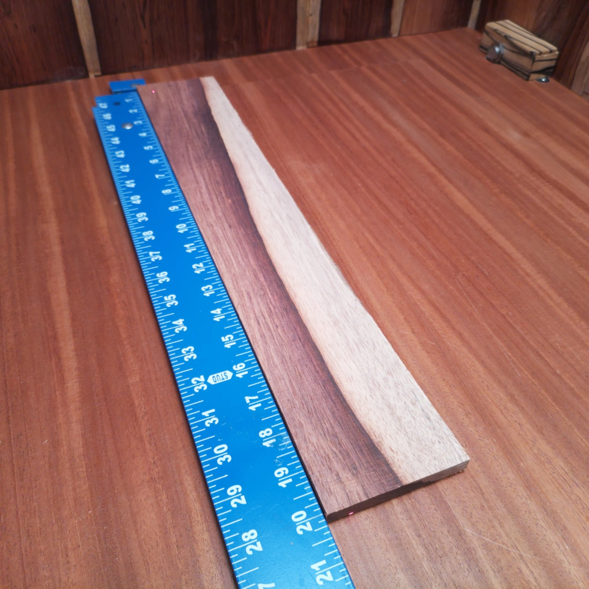 Honduran Rosewood Acoustic Rift Sawn Fingerboard Blank 0.4" X 3.3" X 20.0" - HRAFBR000202 2 Unlock your creative potential with this premium Honduran Rosewood blank, perfect for luthiers. Its rich tonal qualities offer a warm, resonant sound that will elevate any acoustic instrument. With striking grain patterns, this wood not only performs beautifully but also looks stunning in all your creations. Get ready to craft a masterpiece that sounds as great as it looks! It is a Honduran Rosewood Acoustic Rift Sawn fingerboard blank with dimensions of 20.0 x 3.3 x 0.4 inches.