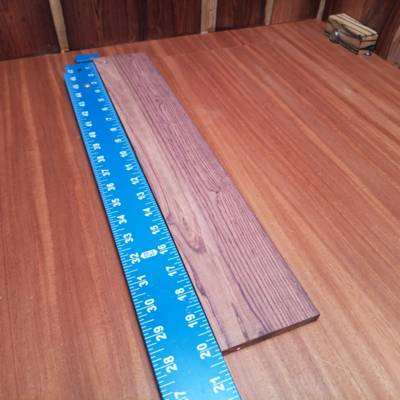 Honduran Rosewood Acoustic Rift Sawn Fingerboard Blank 0.4" X 3.4" X 20.1" - HRAFBR000205 3 Crafted from stunning Honduran rosewood, this acoustic fingerboard blank offers a smooth, resonant surface. Perfect for luthiers seeking rich tonal quality and aesthetic appeal, its rift-sawn grain provides stability and beauty. Elevate your stringed instrument projects with this premium blank, designed for durability and exceptional craftsmanship. Whether you're building or restoring, this blank is the ideal choice for achieving professional results. It is a Honduran Rosewood Acoustic Rift Sawn fingerboard blank with dimensions of 20.1 x 3.4 x 0.4 inches.