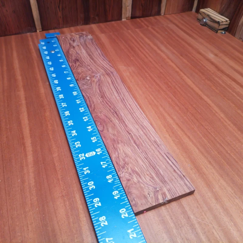 Fingerboard Blanks 56 Elevate your craft with this Honduran rosewood fingerboard blank. Perfect for luthiers, its rift sawn design ensures stability and excellent tonal clarity. With rich, warm tones and a beautiful grain pattern, this fingerboard will enhance any acoustic instrument. Ideal for both novice and seasoned builders, this blank is a must-have for your workshop essentials. Get ready to create music that resonates with elegance and character! It is a Honduran Rosewood Acoustic Rift Sawn fingerboard blank with dimensions of 20.1 x 3.4 x 0.3 inches.