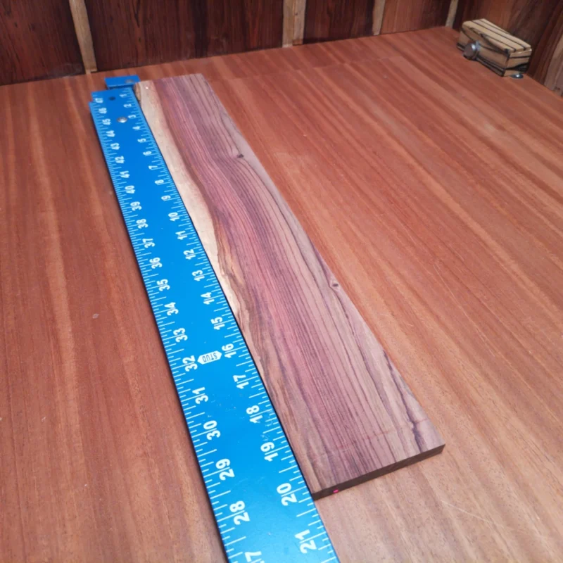 Honduran Rosewood Acoustic Rift Sawn Fingerboard Blank 0.4" X 3.2" X 20.1" - HRAFBR000213 3 Discover the beauty of Honduran Rosewood with this premium fingerboard blank. Perfect for luthiers, it boasts intricate grain patterns and excellent tonal qualities. Dive into your next build with a blank that not only looks stunning but also enhances sound resonance and playability. Create a masterpiece that feels as good as it sounds with this durable, versatile wood that's tailored for high-end acoustic instruments. It is a Honduran Rosewood Acoustic Rift Sawn fingerboard blank with dimensions of 20.1 x 3.2 x 0.4 inches.