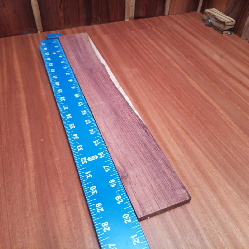 Honduran Rosewood Acoustic Rift Sawn Fingerboard Blank 0.4" X 2.9" X 20.1" - HRAFBR000218 3 This Honduran Rosewood blank offers an impeccable choice for luthiers seeking premium acoustics. Its rift sawn grain ensures consistent tonal quality and mesmerizing aesthetics, perfect for artisan craftsmanship. Designed for durability and resonance, this blank elevates your instrument to pro-level performance, whether you’re crafting guitars or decorative pieces. Get ready to create stunning, unforgettable sound profiles with this high-quality timber. It is a Honduran Rosewood Acoustic Rift Sawn fingerboard blank with dimensions of 20.1 x 2.9 x 0.4 inches.