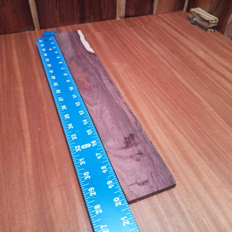 Honduran Rosewood Acoustic Rift Sawn Fingerboard Blank 0.4" X 2.9" X 20.2" - HRAFBR000222 3 Craft your next acoustic masterpiece with this stunning Honduran Rosewood fingerboard blank. The rich colors and unique grain patterns make it a favorite among luthiers. Perfect for adding warmth and depth to your guitar's tone, this durable wood offers exceptional playability. Whether you're a seasoned pro or a budding luthier, this fingerboard blank is the ideal canvas for your creativity, transforming your instrument into a true work of art. It is a Honduran Rosewood Acoustic Rift Sawn fingerboard blank with dimensions of 20.2 x 2.9 x 0.4 inches.