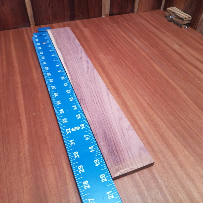 Honduran Rosewood Acoustic Rift Sawn Fingerboard Blank 0.4" X 2.8" X 20.1" - HRAFBR000223 3 Elevate your crafting projects with our Honduran Rosewood blank, perfect for acoustic instruments. Sustainably sourced and rift sawn, this high-quality wood offers a stunning grain pattern and durability. Ideal for luthiers ready to create beautiful soundboards or necks. Experience rich tonal qualities and precision craftsmanship with your new favorite workhorse! It is a Honduran Rosewood Acoustic Rift Sawn fingerboard blank with dimensions of 20.1 x 2.8 x 0.4 inches.