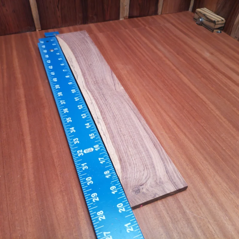 Honduran Rosewood Acoustic Rift Sawn Fingerboard Blank 0.4" X 3.3" X 20.1" - HRAFBR000239 3 Craft your next masterpiece with this Honduran Rosewood blank, featuring a stunning rift sawn cut. Ideal for luthiers, it offers vibrant tones and rich durability, perfect for acoustic builds. Elevate your craftsmanship and impress with this beautifully grained wood that resonates with every string. Make your sound dreams a reality with this premium fingerboards blank! It is a Honduran Rosewood Acoustic Rift Sawn fingerboard blank with dimensions of 20.1 x 3.3 x 0.4 inches.