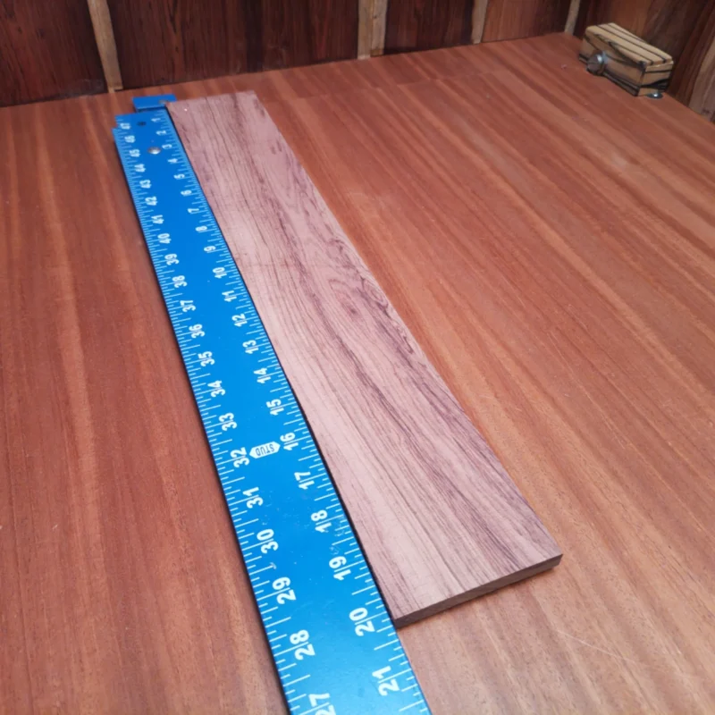 Honduran Rosewood Acoustic Rift Sawn Fingerboard Blank 0.4" X 3.1" X 20.2" - HRAFBR000247 3 This Honduran Rosewood acoustic blank is a superb choice for luthiers seeking durability and beauty. With rich tones and a stunning visual appeal, it enhances any musical instrument you create. Experience the rich sustain and clarity this exquisite blank brings to your guitar projects, allowing your craftsmanship to shine. Perfect for those who appreciate the blend of quality and performance in their builds. It is a Honduran Rosewood Acoustic Rift Sawn fingerboard blank with dimensions of 20.2 x 3.1 x 0.4 inches.