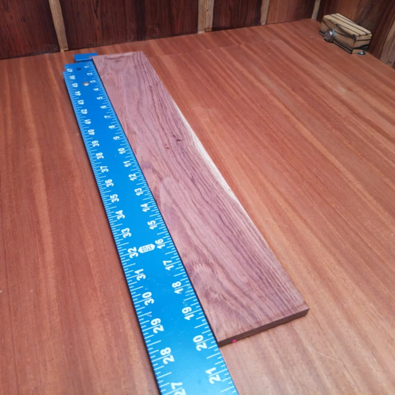 Honduran Rosewood Acoustic Rift Sawn Fingerboard Blank 0.4" X 3.3" X 20.2" - HRAFBR000249 3 This Honduran Rosewood blank is perfect for building acoustic instruments. With its unique rift-sawn grain, it offers stunning aesthetics alongside excellent tonal qualities. Whether you're crafting a guitar or another string instrument, this wood provides the durability and resonate character needed for great sound. Elevate your artistry with this choice material that stands up to the rigors of luthier work while impressing musicians with its visual appeal and auditory charm. It is a Honduran Rosewood Acoustic Rift Sawn fingerboard blank with dimensions of 20.2 x 3.3 x 0.4 inches.