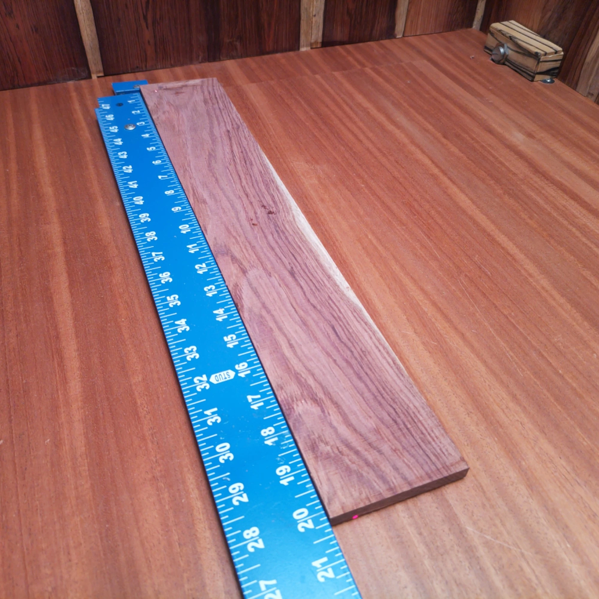 Honduran Rosewood Acoustic Rift Sawn Fingerboard Blank 0.4" X 3.3" X 20.2" - HRAFBR000249 2 This Honduran Rosewood blank is perfect for building acoustic instruments. With its unique rift-sawn grain, it offers stunning aesthetics alongside excellent tonal qualities. Whether you're crafting a guitar or another string instrument, this wood provides the durability and resonate character needed for great sound. Elevate your artistry with this choice material that stands up to the rigors of luthier work while impressing musicians with its visual appeal and auditory charm. It is a Honduran Rosewood Acoustic Rift Sawn fingerboard blank with dimensions of 20.2 x 3.3 x 0.4 inches.
