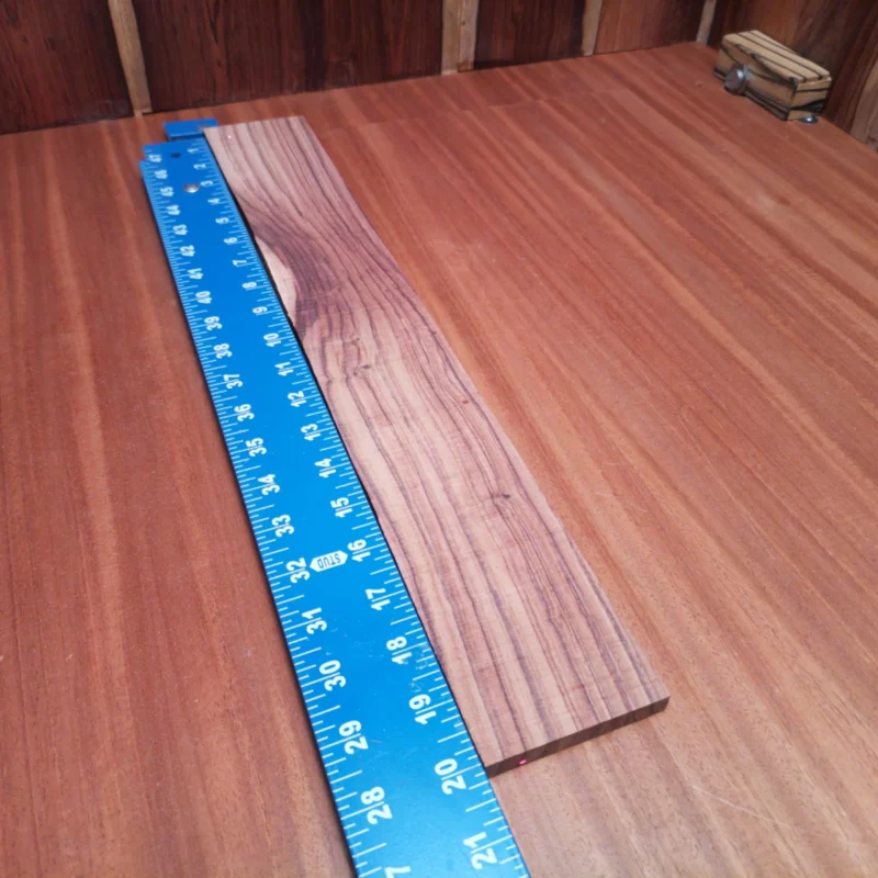 Fingerboard Blanks 156 Unlock your creativity with this Honduran Rosewood fingerboard blank, perfect for luthiers seeking premium materials. Its stunning rift sawn grain offers both beauty and functionality, ensuring top-notch playability and aesthetics for any instrument. Lightweight yet durable, this blank is ideal for crafting exquisite fingerboards that will elevate your building projects to new heights. It is a Honduran Rosewood Acoustic Rift Sawn fingerboard blank with dimensions of 20.1 x 2.8 x 0.4 inches.