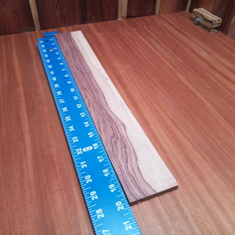 Elevate your luthiery game with our Honduran Rosewood fingerboard blank. Perfect for crafting premium acoustic instruments, this rift-sawn wood showcases striking grain patterns and rich tonal qualities. Ideal for acoustic guitars, this blank combines beauty with functionality, ensuring your creations resonate with warmth and clarity. Whether you're a seasoned luthier or a weekend warrior, this fingerboard blank will help you bring your musical visions to life! It is a Honduran Rosewood Acoustic Rift Sawn fingerboard blank with dimensions of 20.1 x 2.8 x 0.4 inches.