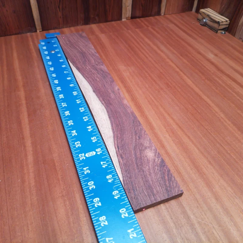 Unlock your creativity with this Honduran Rosewood fingerboard blank, perfect for luthiers seeking quality and beauty. Its rich grain and robust density provide an excellent canvas for acoustic guitars. Imagine crafting instruments that resonate with warm tones and stunning aesthetics. With its ideal dimensions, this fingerboard blank is ready for your next masterpiece! It is a Honduran Rosewood Acoustic Rift Sawn fingerboard blank with dimensions of 20.1 x 2.9 x 0.4 inches.