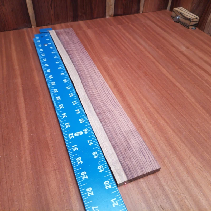 Craft your dream fingerboard with this premium Honduran Rosewood blank. Designed specifically for luthiers, its rift-sawn cut enhances tonal clarity and stability. The rich, warm tones of rosewood will elevate any build and truly impress. Elevate your craftsmanship today with this beautiful, high-quality material. It is a Honduran Rosewood Acoustic Rift Sawn fingerboard blank with dimensions of 20.1 x 2.7 x 0.4 inches.
