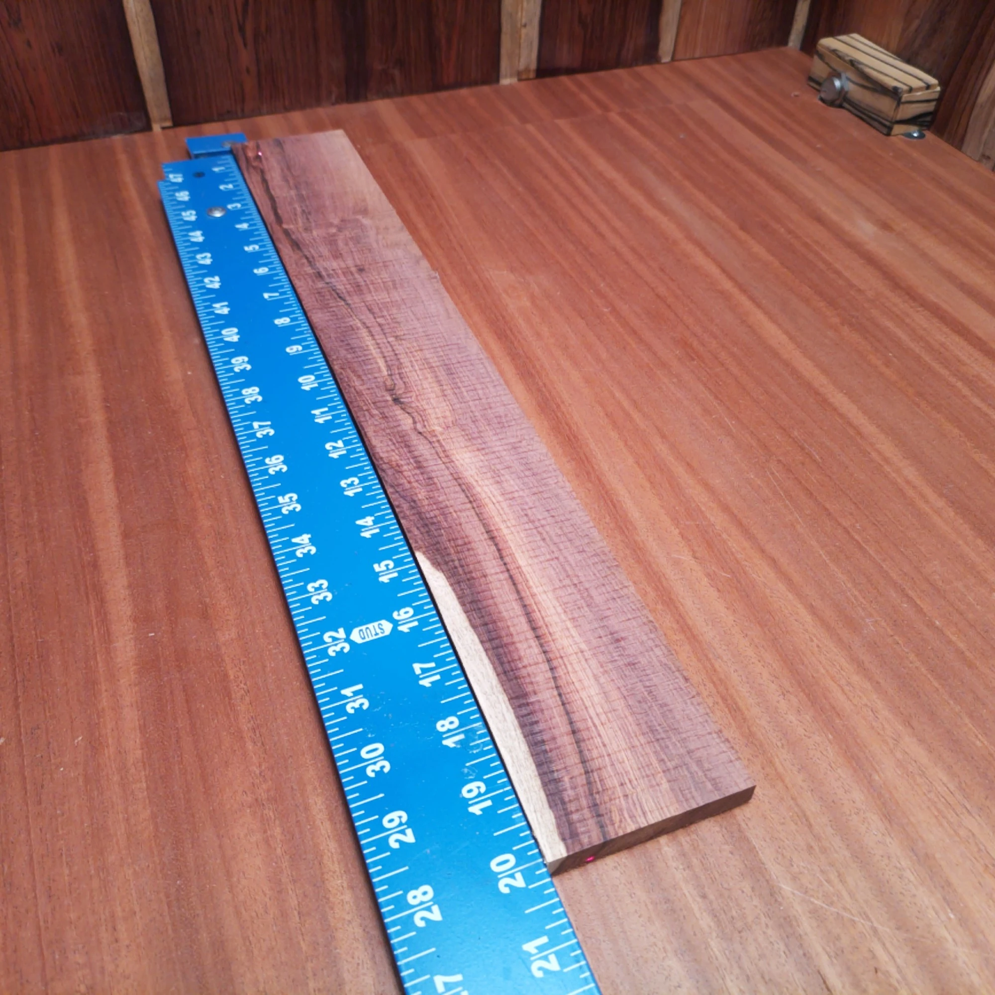 Honduran Rosewood Acoustic Rift Sawn Fingerboard Blank 0.4" X 2.9" X 20.1" - HRAFBR000316 2 Crafted from premium Honduran rosewood, this fingerboards blank promises superior tonal quality and beautiful aesthetics. Perfect for luthiers seeking a reliable material for their next acoustic project, it's dimensionally precise and ready for your creativity. Unleash your craftsmanship with this versatile blank, ideal for solid builds and nuanced sound. Transform your designs and elevate your music with unparalleled warmth and resonance! It is a Honduran Rosewood Acoustic Rift Sawn fingerboard blank with dimensions of 20.1 x 2.9 x 0.4 inches.