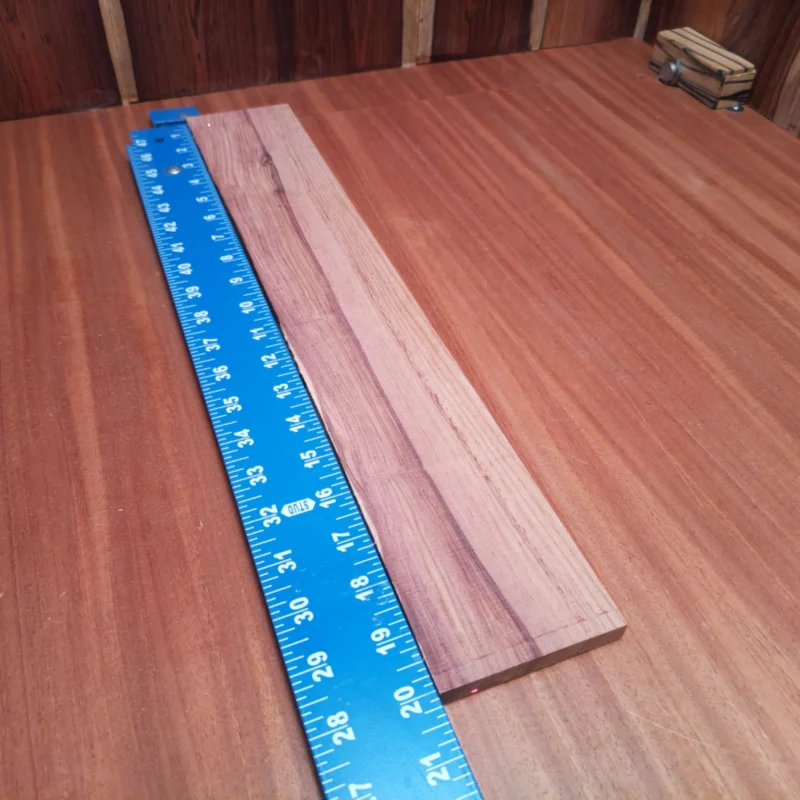 Honduran Rosewood Acoustic Rift Sawn Fingerboard Blank 0.4" X 3.2" X 20.1" - HRAFBR000329 3 Craft your next acoustic masterpiece with this Honduran Rosewood fingerboard blank. Known for its incredible tonal richness and beautiful grain, this blank is perfect for luthiers looking to elevate their builds. Ideal for those seeking durability and a luxurious feel, this rosewood will help you create harmonious melodies that resonate with depth and clarity. Grab this unique piece to enhance your instruments and captivate your audience. It is a Honduran Rosewood Acoustic Rift Sawn fingerboard blank with dimensions of 20.1 x 3.2 x 0.4 inches.