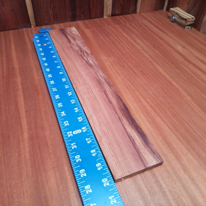Unlock your creativity with this Honduran Rosewood acoustic fingerboard blank. Crafted from premium rift sawn wood, it promises durability while delivering a rich, resonant tone. Perfect for luthiers aiming to create exceptional instruments, this blank is not just a surface; it's a canvas for your artistry. Whether you're a pro or a beginner, your guitar projects will truly flourish with this high-quality material at hand. It is a Honduran Rosewood Acoustic Rift Sawn fingerboard blank with dimensions of 20.0 x 3.2 x 0.4 inches.