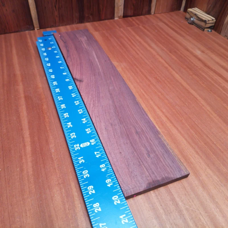 Unlock the potential of your next acoustic project with our Honduran Rosewood blank. This premium rift-sawn wood promises superior tonal quality, ensuring vibrant resonance in your instrument. Its rich, dark grains offer stunning aesthetic appeal, making every piece a conversation starter. Perfect for luthiers seeking quality materials that combine beauty and functionality, this blank is a must-have for crafting your next masterpiece. It is a Honduran Rosewood Acoustic Rift Sawn fingerboard blank with dimensions of 20.1 x 4.0 x 0.4 inches.