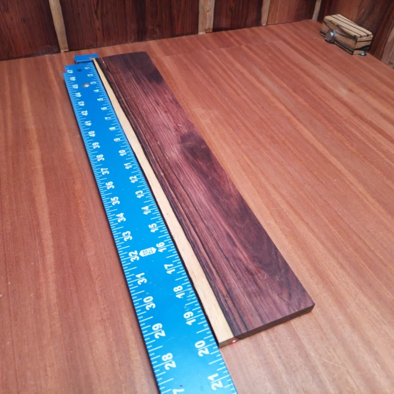 Discover the ultimate fingerboard blank crafted from Honduran Rosewood. This rift sawn beauty is perfect for luthiers looking to amp up their acoustic guitars. With a rich tone and stunning grain, it enhances playability and durability. Elevate your stringed instrument projects with this high-quality blank that's sure to impress. Get ready to create your next masterpiece with this versatile and luxurious wood! It is a Honduran Rosewood Acoustic Rift Sawn fingerboard blank with dimensions of 20.0 x 3.5 x 0.4 inches.