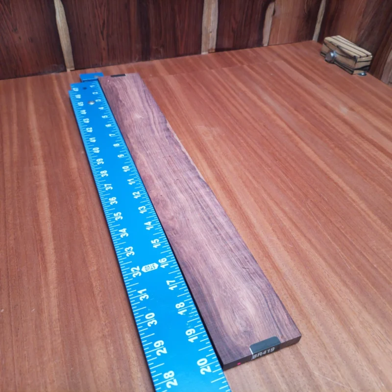 Fingerboard Blanks 105 Elevate your craft with this Honduran Rosewood blank, perfect for acoustic instruments. Its stunning grain and rich tonal qualities make it a favorite among luthiers. This durable wood not only resonates beautifully but also brings a touch of elegance to any build. Whether you’re crafting guitars or other stringed instruments, this blank promises quality and style. Get ready to impress your audience with enhanced sound and aesthetics! It is a Honduran Rosewood Acoustic Rift Sawn fingerboard blank with dimensions of 20.1 x 2.7 x 0.4 inches.