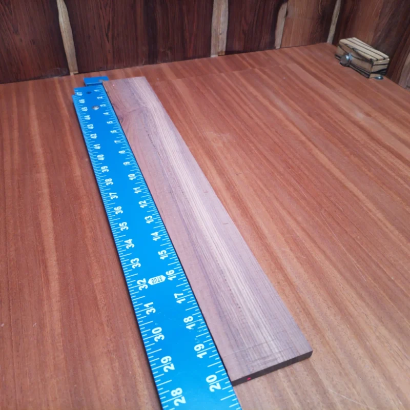Fingerboard Blanks 107 Unlock your creativity with this premium Honduran Rosewood blank, perfect for luthiers who demand quality. With its rich color and fine grain, this acoustic fingerboard blank ensures stunning aesthetics and exceptional durability. Make your instruments stand out while enjoying the warmth and clarity of sound that Honduran Rosewood offers. Whether you're crafting a new masterpiece or repairing an old favorite, this is the wood that will elevate your work. It is a Honduran Rosewood Acoustic Rift Sawn fingerboard blank with dimensions of 20.1 x 2.7 x 0.4 inches.