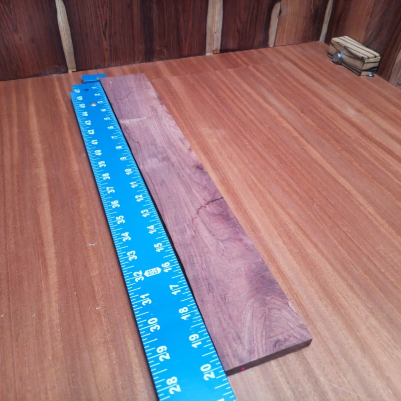 Elevate your craft with this Honduran Rosewood fingerboard blank. Perfectly rift-sawn, it offers a stunning balance of rich tonal qualities and aesthetic appeal. Ideal for luthiers, its versatility makes it suitable for various stringed instruments. This blank is ready to shape, sand, and transform into your next masterpiece. Its dense, durable nature ensures longevity and a smooth playing experience, allowing musicians to deliver exceptional performances. Join the trend and unleash your creativity! It is a Honduran Rosewood Acoustic Rift Sawn fingerboard blank with dimensions of 20.2 x 2.9 x 0.4 inches.