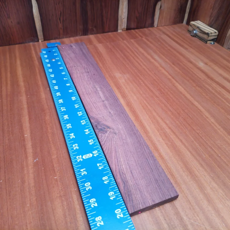 Fingerboard Blanks 49 Crafted from premium Honduran rosewood, this acoustic blank delivers rich tones and stunning aesthetics. Ideal for luthiers aiming to create exceptional instruments, this fingerboard blank ensures durability with its rift sawn construction. The naturally dense wood provides excellent resonance and projection, making every strum a melodious delight. Enjoy the perfect balance of beauty and functionality in your next guitar project. It is a Honduran Rosewood Acoustic Rift Sawn fingerboard blank with dimensions of 20.2 x 3.1 x 0.3 inches.