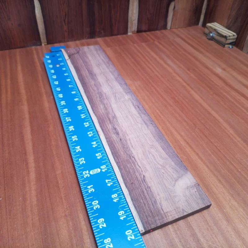 Honduran Rosewood Acoustic Rift Sawn Fingerboard Blank 0.4" X 4.0" X 20.0" - HRAFBR000501 3 Crafted for the discerning luthier, this Honduran Rosewood blank pairs premium aesthetics with remarkable tonal qualities. Perfectly suited for crafting acoustic instruments, it offers excellent clarity and warmth, ensuring your creations stand out. The elegant rift sawn grains enhance visual appeal while providing structural stability. Whether you're a seasoned pro or an enthusiastic beginner, this blank is your ticket to achieving musical excellence. It is a Honduran Rosewood Acoustic Rift Sawn fingerboard blank with dimensions of 20.0 x 4.0 x 0.4 inches.