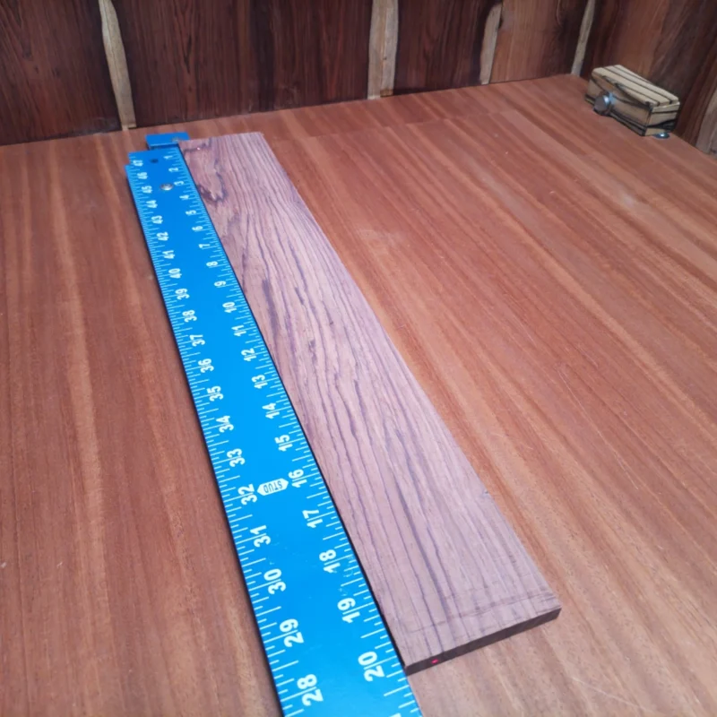 Elevate your next luthier project with this premium Honduran Rosewood blank. Its rich tonal qualities and stunning rift-sawn grain make it ideal for crafting vibrant acoustic instruments. Perfect for guitars, ukuleles, or any string instrument, this blank ensures durability and a beautiful finish, drawing musicians to its playability. Work with a piece that combines both aesthetic appeal and exceptional sound quality, and let your creativity blossom! It is a Honduran Rosewood Acoustic Rift Sawn fingerboard blank with dimensions of 20.2 x 3.0 x 0.4 inches.