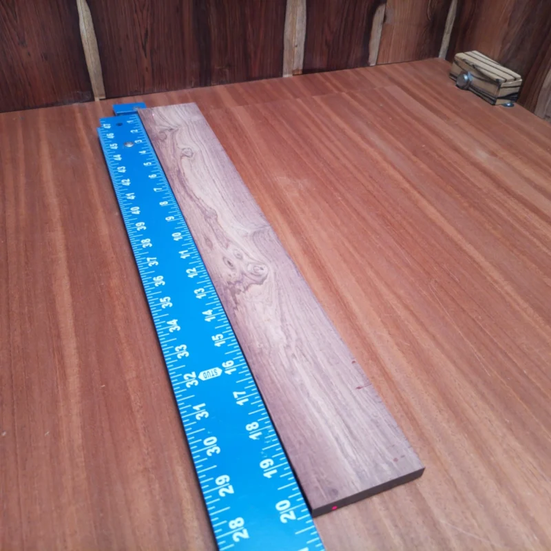 Honduran Rosewood Acoustic Rift Sawn Fingerboard Blank 0.4" X 2.8" X 20.2" - HRAFBR000532 3 Unleash your creativity with our Honduran Rosewood fingerboards blank. This premium wood delivers beautiful tonal qualities, perfect for luthiers wanting to craft stunning acoustic guitars. Its lustrous grain adds a touch of elegance, while its stability ensures durability in any project. Get ready to enhance your instrument with this reliable and stylish blank that meets all your luthier needs. It is a Honduran Rosewood Acoustic Rift Sawn fingerboard blank with dimensions of 20.2 x 2.8 x 0.4 inches.