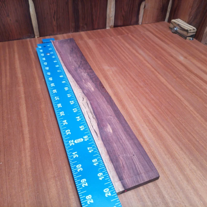 Fingerboard Blanks 121 Unleash your creativity with this Honduran Rosewood fingerboards blank! Perfectly rift-sawn for optimal tonal richness, it enhances any acoustic instrument. Luthiers will appreciate the durable, fine grain structure, which ensures both beauty and stability. Ideal for crafting high-quality fingerboards, this blank is your go-to choice for creating exceptional sound and style. Get ready to impress players with your craftsmanship! It is a Honduran Rosewood Acoustic Rift Sawn fingerboard blank with dimensions of 20.2 x 2.7 x 0.4 inches.